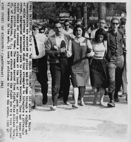 Arrests of "walk-inners" seeking racial integration of Gwynn Oak amusement park in Baltimore, including Arthur Waskow (carrying shoes)