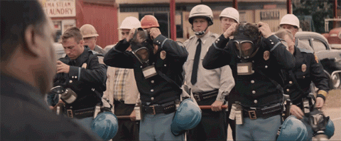 Alabama troopers don gas masks, prepafing to gas marchers in Selma