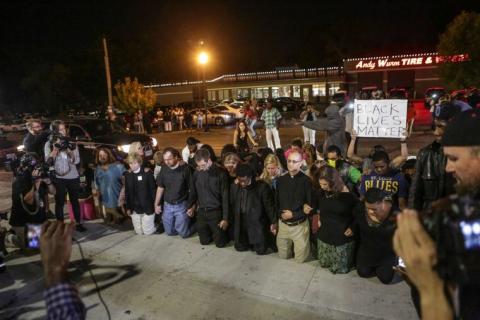   Rabbis are among those praying at the Ferguson police station for justice in the Michael Brown case. Rabbi Talve is on the right, in front of the person in the St. Louis Blues shirt; Rabbi Randy Fleisher is on the far left, in blue, with long hair.