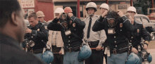 MLK faces Alabama state troops, donning gas masks as they prepare to gas demonstrators at the Edmund Pettus bridge